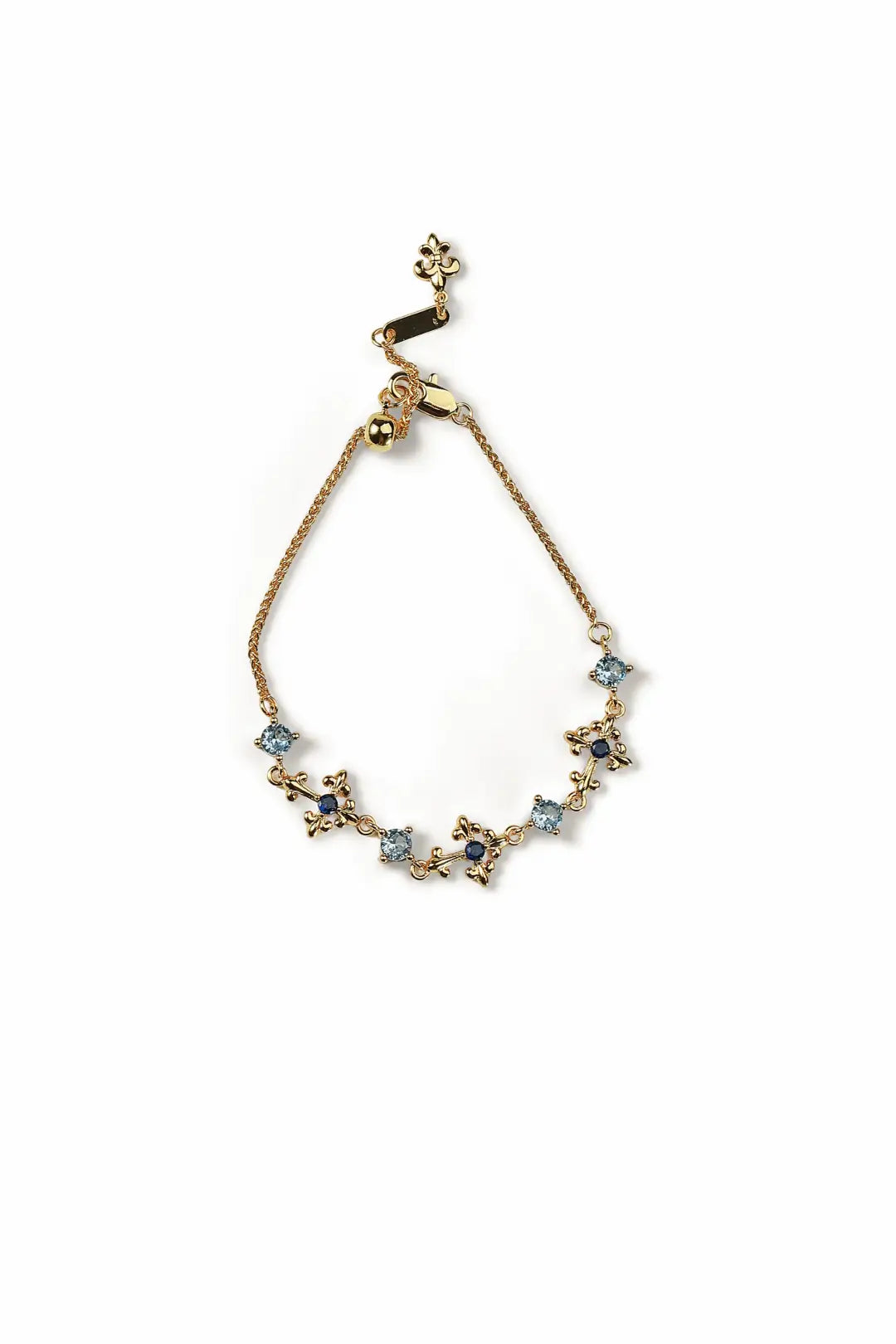 Aiko Tanaka Sazanami bracelet, a gold slider chain with small blue and clear stone flowers, on a white background